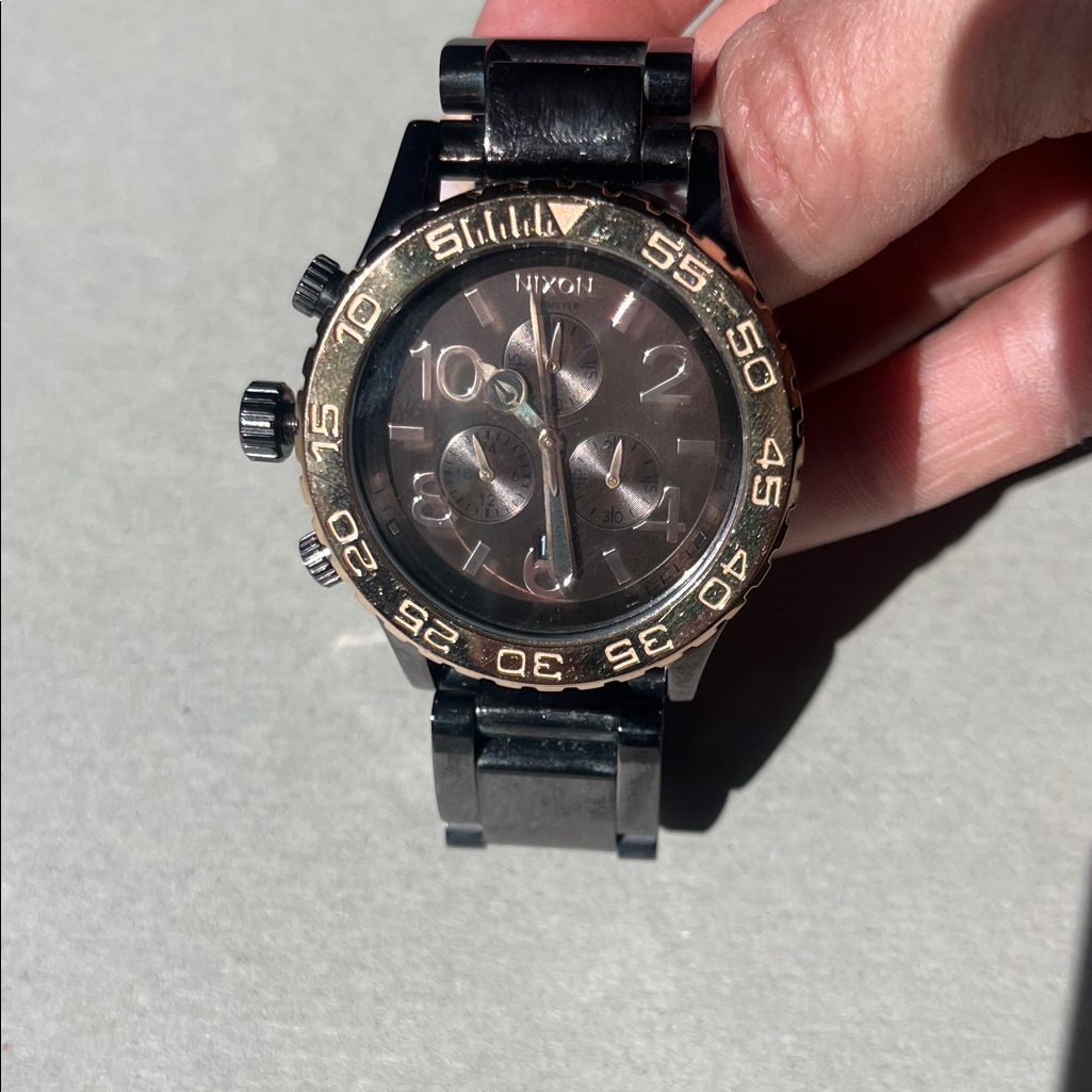 Nixon Black And Gold Chronograph Timepiece